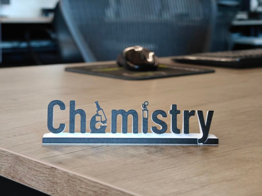Chemistry-themed office nameplate on a desk